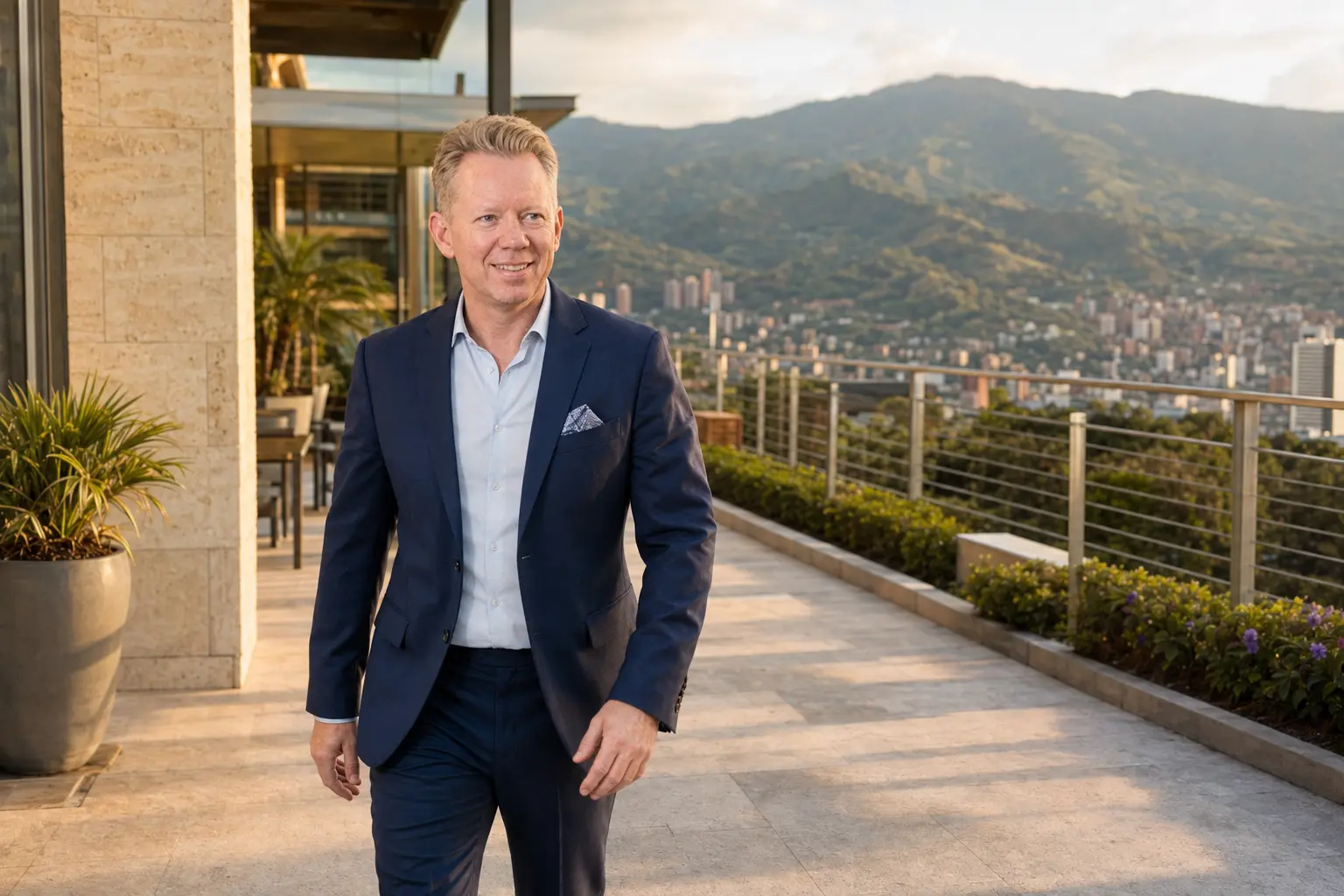 John Benedict walking on a terrace above Medellín
